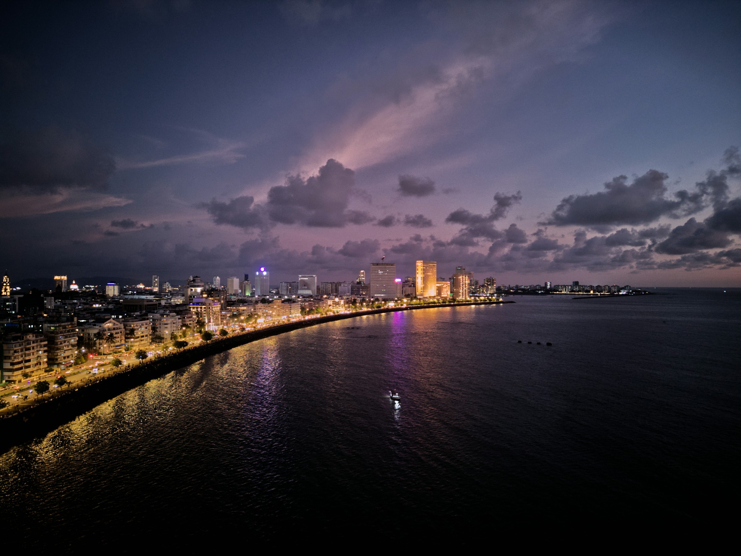 Marine Drive at dusk with the Mumbai skyline reflected along the Arabian Sea